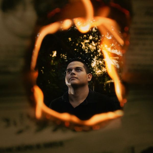 Silhouette of a man stretching against a sunrise, symbolizing energy and a new beginning.